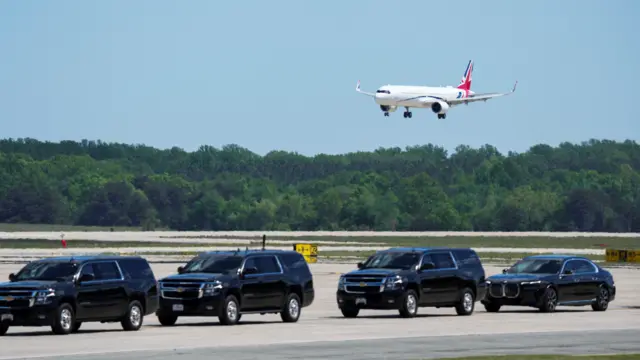 A plane with a Union Jack approaches the tarmac to land