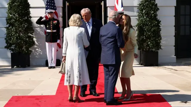Queen Camilla shakes Donald Trump's hand while King Charles kisses Melania Trump on the cheek at the White House.