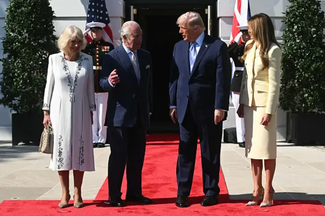 Queen Camilla, King Charles, Donald Trump and Melania Trump stand in a line outside the White House.