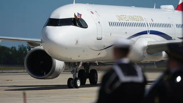 The plane has landed, figures can be seen in the foreground