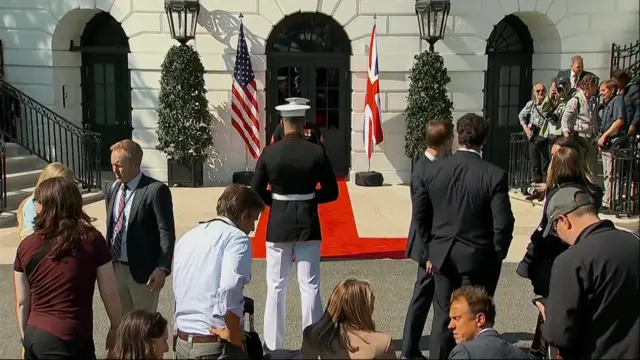 A view of people outside the entrance to the White House.