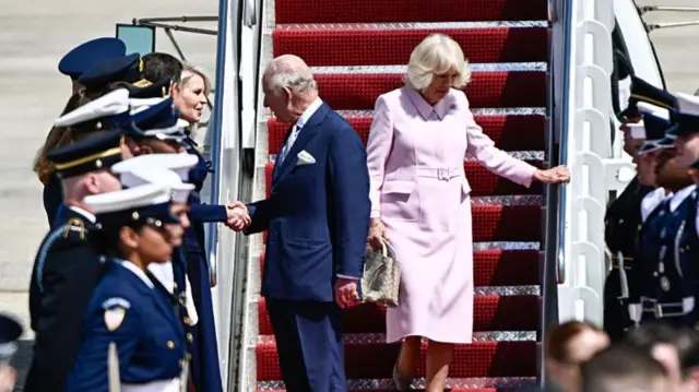 Britain's King Charles III and Britain's Queen Camilla are greeted by US Chief of Protocol Monica Crowley upon arrival at Joint Base Andrews, Maryland, on April 27, 2026.