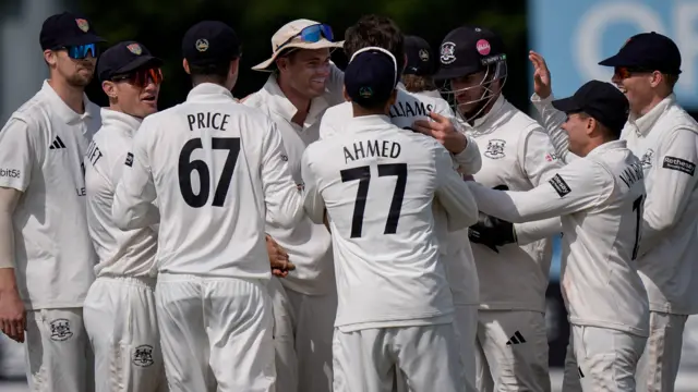 Gloucestershire players celebrate a wicket for Ed Middleton against Derbyshire