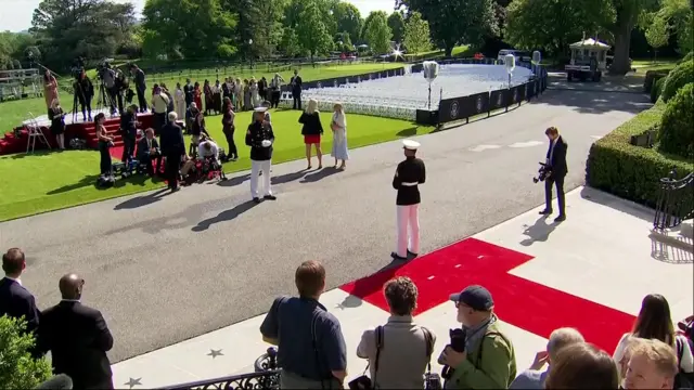 People stood outside White House with red carpet rolled out.