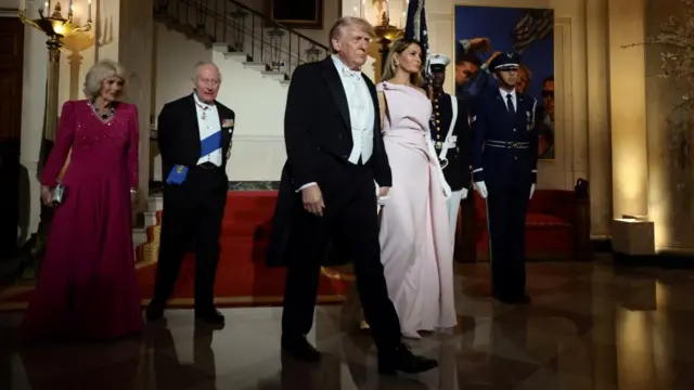 U.S. President Donald Trump, first lady Melania Trump, Britain's King Charles and Queen Camila walk in front of the Grand Staircase prior to a state dinner