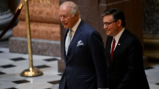 King and Mike Johnson walk through the Capitol building