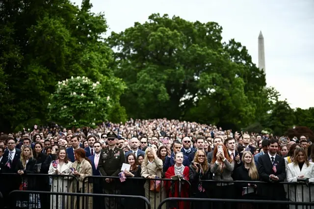 Large crowds gather outside the White House to watch the ceremony unfold.