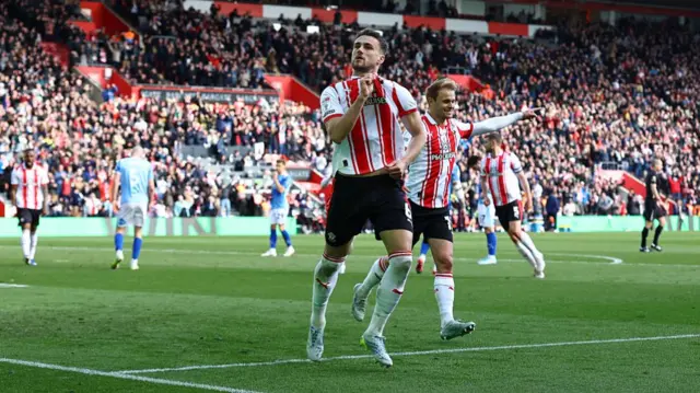 Southampton's Taylor Harwood-Bellis clutches the team badge in celebration