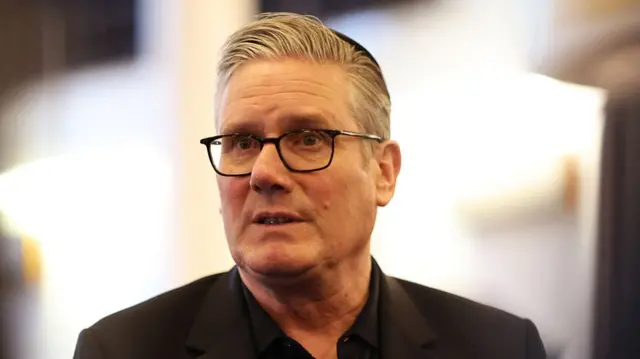 Keir Starmer talking to a reporter slightly off camera