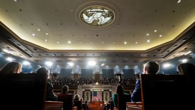 A low, rear view down the aisle of the House of Representatives.
