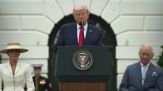 Donald Trump speaking at a podium outside the White House.