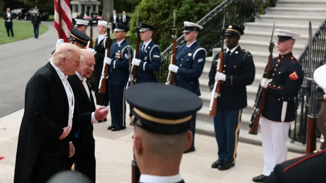 President Donald Trump and Britain's King Charles III walk at the South Portico as they arrive for a state dinner.