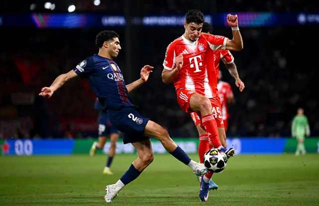 Aleksandar Pavlovic is challenged by Achraf Hakimi