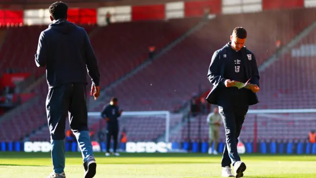 An Ipswich player reads the matchday programme at St Mary's