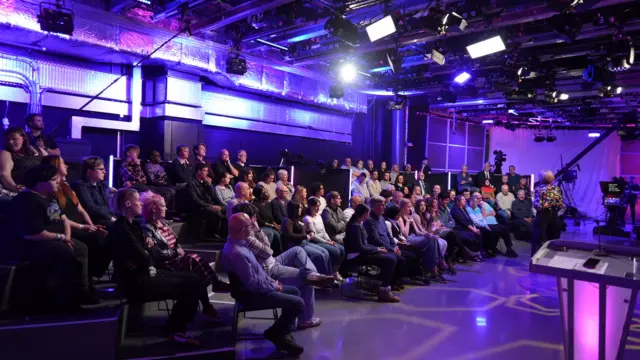 The audience sits inside the studio waiting for the debate to begin.