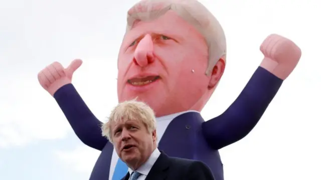 Boris Johnson in front of inflatable model of himself