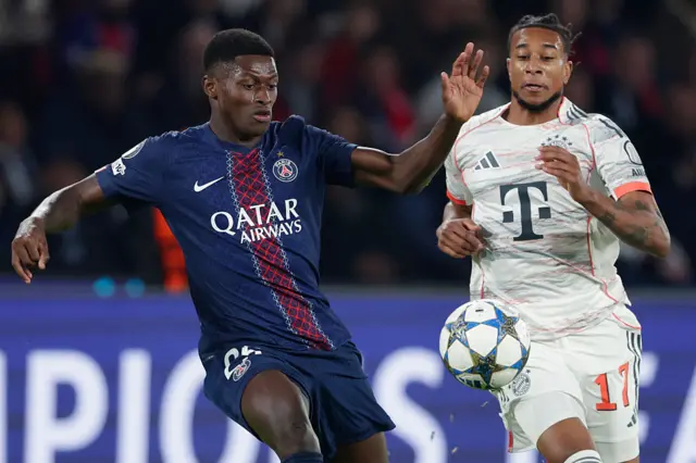 Nuno Mendes and Michael Olise competing for the ball