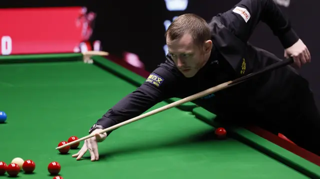 Mark Allen plays a shot