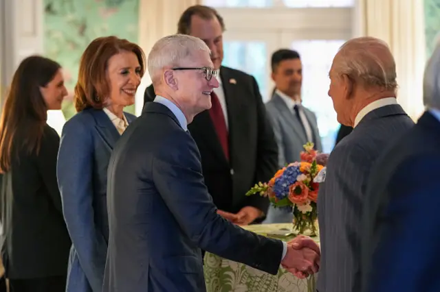 King Charles shakes Apple CEO Tim Cook's hand at a gathering