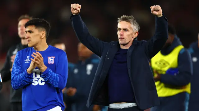 Kieran McKenna raises both fists in the air in celebration