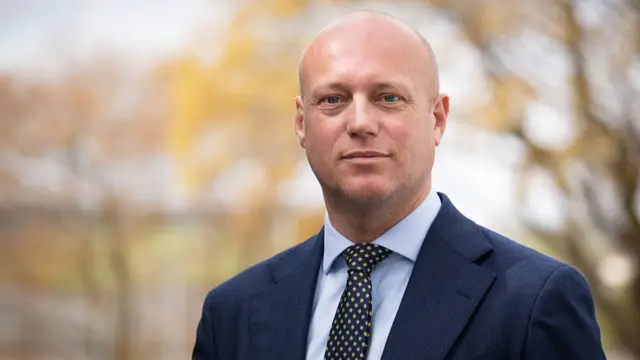 Dan Thomas wearing a suit