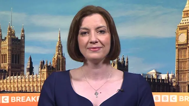 Bridget Phillpson appearing in front of the BBC Breakfast background, with the Palace of Westminster visible. She is wearing a navy dress and a silver necklace.