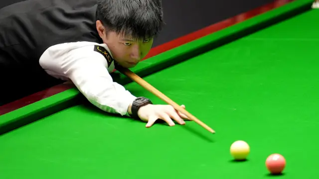 Zhao Xintong plays a shot