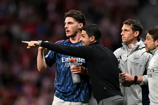 Declan Rice receives instructions from Mikel Arteta
