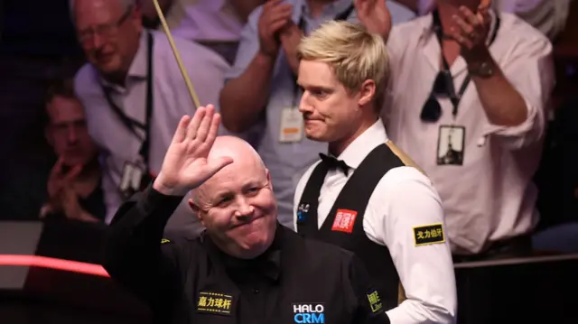 John Higgins celebrates