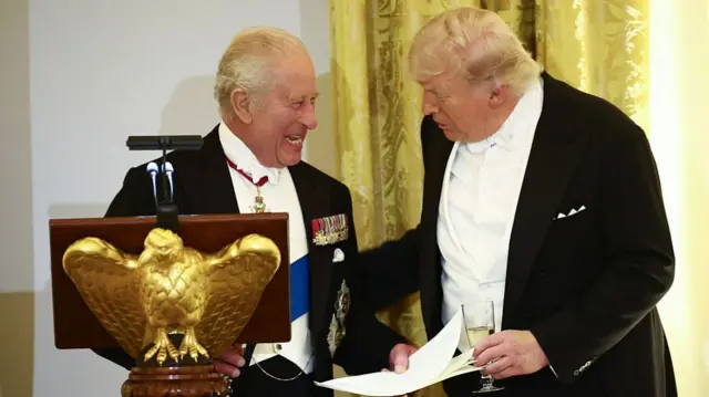 The King and Trump smile at a state dinner