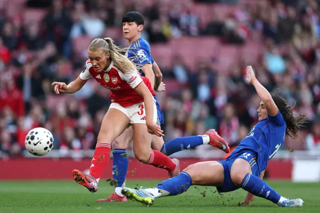 Smilla Holmberg of Arsenal scores her team's second goal ahead of Julie Thibaud of Leicester City