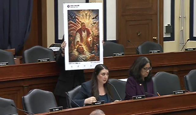 Democratic Congresswoman Sara Jacobs with a cardboard cut out of Trump's post being held behind her