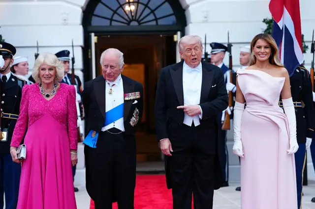 The first lady is wearing a pale delphinium pink silk strapless gown by Christian Dior Haute Couture, with off-white Dior suede gloves. Dior pale delphinium silk pumps.