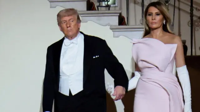Donald Trump hold the hands of wife Melania