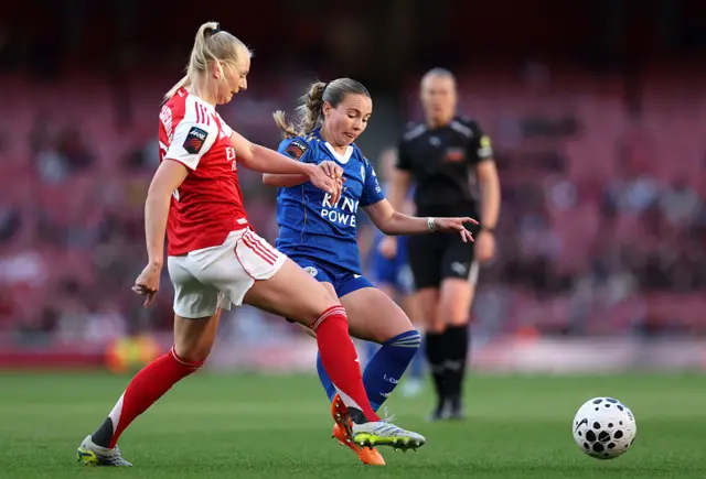 Frida Maanum of Arsenal is challenged by Olivia McLoughlin of Leicester City