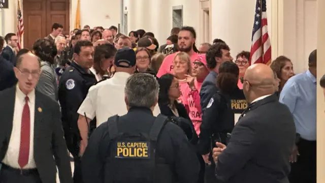 Security and public congregate outside the hearing at the Capitol