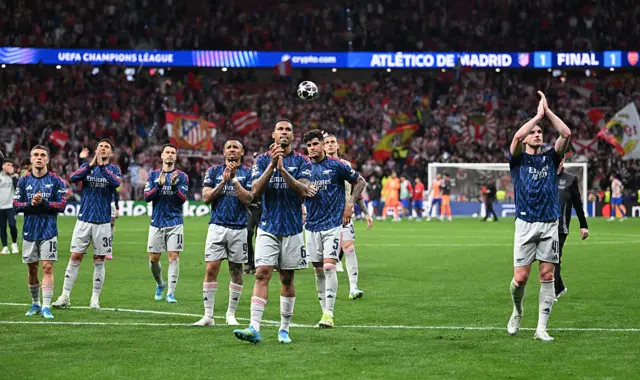 Arsenal applaud travelling fans.