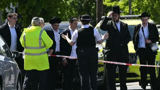 Police speak to people from the cordon in Golders Green