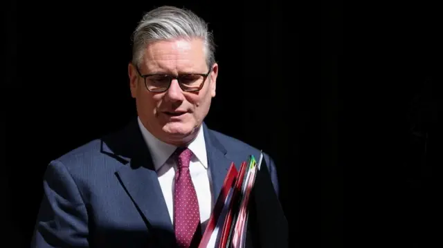 Prime Minister Keir Starmer walks out of No 10 Downing Street