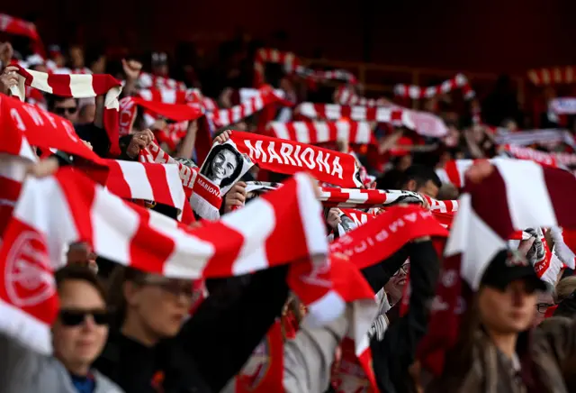 Arsenal scarves held aloft