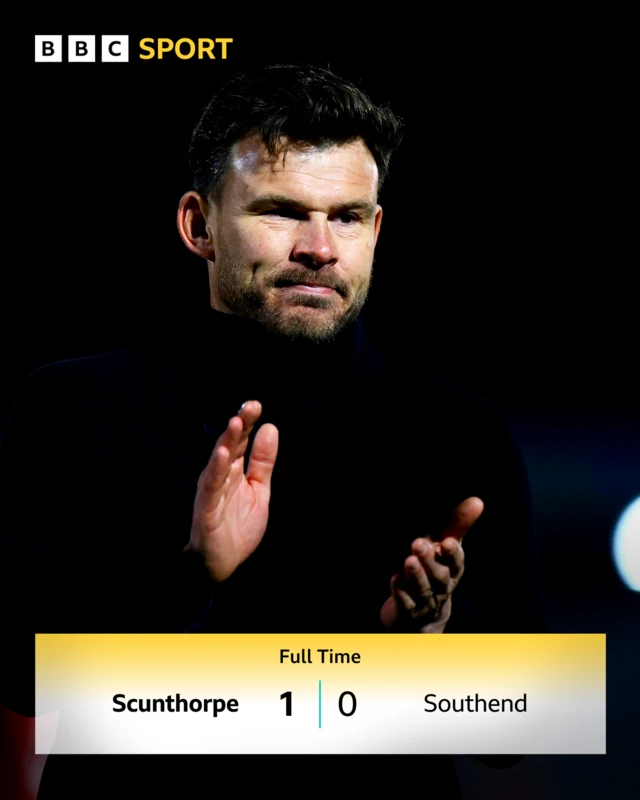 A photo of Scunthorpe boss Andy Butler applauding above the score line from yesterday's 1-0 win over Southend