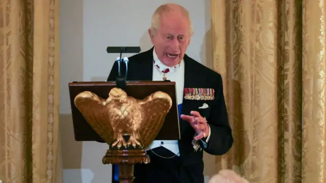 Charles gestures during speech