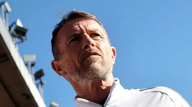 Leicester City boss Gary Rowett looking towards the pitch from the dugout with the camera directly below him.
