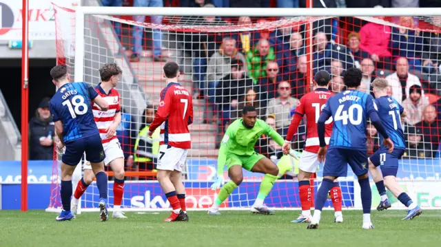 Rhys Oates deflects in Mansfield's goal