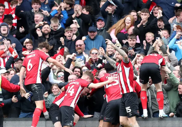 Lincoln celebrate their late winner against AFC Wimbledon