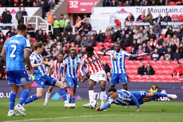 Gabriel Otegbayo of Sheffield Wednesday dives as he attempts to block the shot from Jesurun Rak-Sakyi of Stoke City