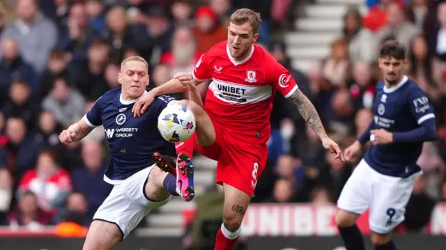Millwall's Casper de Norre (left) and Middlesbrough's Riley McGree battle for the ball