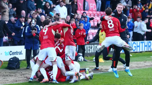 Saflord's players celebrate their late winning goal