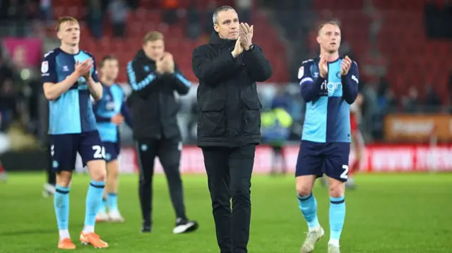 Wycombe boss Michael Duff and players applaud supporters