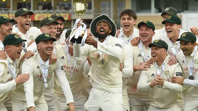 Haseeb Hameed lifts the County Championship trophy at Trent Bridge